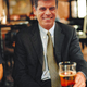 Meyers enjoys a beer at an airport bar in Atlanta.